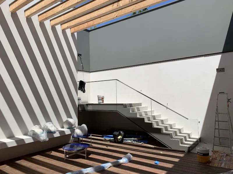 Rénovation extérieure d’un grand volume, murs blancs et escalier